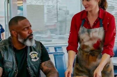 The morning sun hadn’t yet burned through the clouds when the old neon sign of Maggie’s diner flickered to life. The smell of coffee and sizzling bacon filled the air as Emily Carter, wearing her faded red shirt and a grease stained apron, began another long day of work. She had worked at this small town diner for 12 years, serving strangers with a smile, hiding her exhaustion behind gentle eyes that had seen more than she ever spoke about.